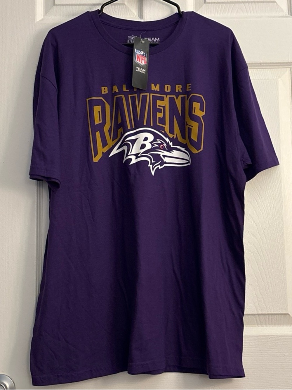 Brand new with tags Men’s Purple XL Baltimore Ravens T-Shirt with gold text